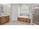 Bathroom with separate shower, tub, tile floors and wood cabinets at 2674 Spicebush Loop, Apopka, FL 32712