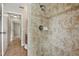This bathroom features tiled walls, tiled floors, silver shower fixtures, and an open doorway at 2674 Spicebush Loop, Apopka, FL 32712