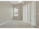 Neutral bedroom with carpet flooring and a window and glass sliding doors for natural light at 2674 Spicebush Loop, Apopka, FL 32712
