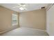 This bedroom features neutral walls, carpet floors, a ceiling fan and a window with light filtering blinds at 2674 Spicebush Loop, Apopka, FL 32712