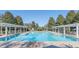 Large community pool with lounge chairs and shaded pergola areas perfect for relaxation and enjoyment at 2674 Spicebush Loop, Apopka, FL 32712
