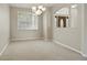 Inviting dining area featuring neutral walls, neutral carpet, and open transition to front entryway at 2674 Spicebush Loop, Apopka, FL 32712