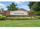 Well-maintained community entrance sign for Arbor Ridge, featuring manicured landscaping and a brick facade at 2674 Spicebush Loop, Apopka, FL 32712