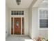 Elegant front door with glass detailing and sidelights, enhancing curb appeal at 2674 Spicebush Loop, Apopka, FL 32712