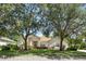 Charming single-story home featuring mature trees and a well-manicured lawn at 2674 Spicebush Loop, Apopka, FL 32712