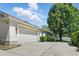 Spacious two-car garage with an expansive driveway and manicured landscaping at 2674 Spicebush Loop, Apopka, FL 32712