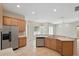 Bright kitchen showcasing stainless steel appliances, ample counter space, and stylish tile flooring at 2674 Spicebush Loop, Apopka, FL 32712