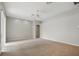 Large living area with neutral carpet, ceiling fan, and a bright atmosphere, ideal for relaxation and entertainment at 2674 Spicebush Loop, Apopka, FL 32712