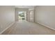 Bright living room featuring neutral carpet and a sliding glass door to the backyard at 2674 Spicebush Loop, Apopka, FL 32712