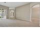 Spacious living room featuring neutral carpet, neutral walls, and open transition to other living spaces at 2674 Spicebush Loop, Apopka, FL 32712