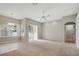Expansive living room with neutral carpet, a ceiling fan, and sliding glass doors for abundant natural light at 2674 Spicebush Loop, Apopka, FL 32712