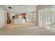 Bright living room features a ceiling fan, and tile floors leading to the kitchen and dining area at 2674 Spicebush Loop, Apopka, FL 32712