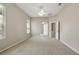 Bright main bedroom with carpet, ceiling fan, ensuite bathroom and large window at 2674 Spicebush Loop, Apopka, FL 32712