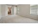 Spacious main bedroom with carpet flooring, large windows, and ensuite bathroom at 2674 Spicebush Loop, Apopka, FL 32712