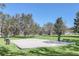 Community volleyball court offering a recreational amenity with a sandy court, net, and surrounding grassy area at 2674 Spicebush Loop, Apopka, FL 32712