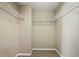 Walk-in closet with carpeted floor and white shelving on all sides at 2674 Spicebush Loop, Apopka, FL 32712