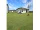 Large backyard featuring a sliding glass door and well-maintained lawn at 2707 Virginia Pine Nw Dr, Bartow, FL 33830