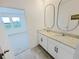 Bright double-sink bathroom with granite countertops, tiled floor, and a view of the bedroom at 2707 Virginia Pine Nw Dr, Bartow, FL 33830