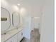 Bathroom with double granite sinks and modern black fixtures plus tile floors at 2707 Virginia Pine Nw Dr, Bartow, FL 33830