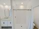 Bathroom featuring a shower and double sinks with granite countertops and modern fixtures at 2707 Virginia Pine Nw Dr, Bartow, FL 33830