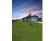 Beautiful single-story home with a well-manicured lawn at sunset at 2707 Virginia Pine Nw Dr, Bartow, FL 33830
