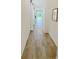 Hallway with tile flooring and a view towards the sliding glass doors at 2707 Virginia Pine Nw Dr, Bartow, FL 33830