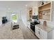 Open kitchen with white cabinets, stainless steel appliances, and a large island at 2707 Virginia Pine Nw Dr, Bartow, FL 33830