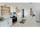 Modern kitchen with white cabinets, stainless steel appliances, and a granite-topped island at 2707 Virginia Pine Nw Dr, Bartow, FL 33830