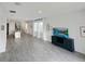 Open-concept living room with tile flooring and lots of natural light from the many windows at 2707 Virginia Pine Nw Dr, Bartow, FL 33830