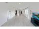 Bright, open-concept living room with tile flooring and modern decor flows into the kitchen at 2707 Virginia Pine Nw Dr, Bartow, FL 33830