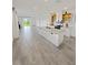 Open-concept living room and kitchen with tile flooring and abundant natural light at 2707 Virginia Pine Nw Dr, Bartow, FL 33830