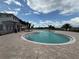 Community pool featuring a zero entry, blue water, fountain, and spacious patio with palm trees at 2707 Virginia Pine Nw Dr, Bartow, FL 33830
