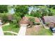 Property aerial view of the home with palm trees, a driveway, and a view of a nearby pond at 2715 Wekiva Meadows Ct, Apopka, FL 32712