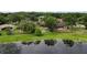 Aerial view of backyard including lake, lush trees and outdoor spaces at 2715 Wekiva Meadows Ct, Apopka, FL 32712