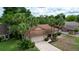 Aerial view of the property with mature trees, a driveway, and a well-kept yard at 2715 Wekiva Meadows Ct, Apopka, FL 32712