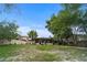View of a home's screened-in back porch and treed backyard space at 2715 Wekiva Meadows Ct, Apopka, FL 32712