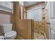 Bathroom with tiled shower and glass door, toilet with a closed lid, and a window for natural light at 2715 Wekiva Meadows Ct, Apopka, FL 32712