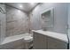 A bathroom features a shower-tub combo and a grey vanity at 2715 Wekiva Meadows Ct, Apopka, FL 32712