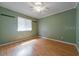 An empty bedroom features hardwood floors and a window with blinds at 2715 Wekiva Meadows Ct, Apopka, FL 32712