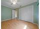 A simple bedroom features hardwood floors and a large closet at 2715 Wekiva Meadows Ct, Apopka, FL 32712