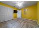 A bedroom features yellow walls, carpeted floors and a closet at 2715 Wekiva Meadows Ct, Apopka, FL 32712