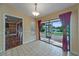 A dining area overlooks the screened in porch and a water view at 2715 Wekiva Meadows Ct, Apopka, FL 32712