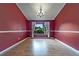 An empty dining room features hardwood floors, base molding, and a decorative chandelier at 2715 Wekiva Meadows Ct, Apopka, FL 32712