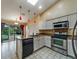 A kitchen features white cabinets, granite counters and stainless steel appliances at 2715 Wekiva Meadows Ct, Apopka, FL 32712