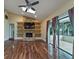 Bright living room featuring a fireplace, built-in shelving, wood floors, and natural light from skylights at 2715 Wekiva Meadows Ct, Apopka, FL 32712