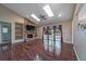 Spacious living room with wood floors, a fireplace, built-in shelves, and access to the outdoors at 2715 Wekiva Meadows Ct, Apopka, FL 32712