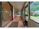 Screened patio with tile flooring, offering views of the spacious backyard and access to the outdoors at 2715 Wekiva Meadows Ct, Apopka, FL 32712
