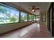 Enclosed patio featuring tiled floors, ceiling fan, and large windows showcasing scenic water views at 2715 Wekiva Meadows Ct, Apopka, FL 32712