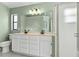 Bright bathroom featuring a double vanity, neutral color scheme, and glass enclosed shower at 2933 Birmingham Blvd, Orlando, FL 32829