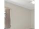 Minimalist bedroom with neutral walls, tiled floors, and a window, providing a calm atmosphere at 2933 Birmingham Blvd, Orlando, FL 32829